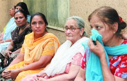 Relatives of an elderly woman Normal Madan who was found murdered at Amar Colony in the Capital