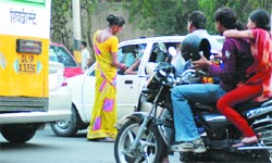A eunuch begs at the ITO crossing in the Capital