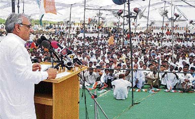 Chief Minister Bhupinder Singh Hooda addresses an election meeting in Mangali village of Adampur assembly constituency on Tuesday.