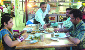 A family savours Punjabi food at Lucky Dhaba.