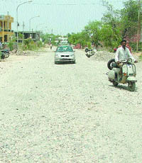 Pot-holed roads give commuters a hard time. 