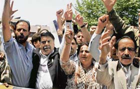 Government employees under the banner of the Jammu and Kashmir Employees Joint Action Committee protest against the government in Srinagar