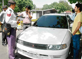 Traffic personnel challan a vehicle on the Panjab University campus in Chandigarh on Wednesday.
