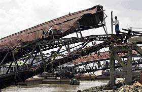 A man stands at the broken pier following devastating cyclone in Yangon