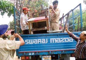 The enforcement staff of the municipal corporation impound rehries of juice sellers during an anti-encroachment drive in Chandigarh on Thursday.