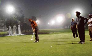 A local participant putts under floodlights on the opening day of the night golf tournament at the Chandigarh Golf Club on Thursday. 