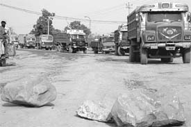Stationary trucks on Jalla road at Chandi Mandir after residents of Burj Kotian village blocked the road. 