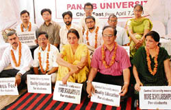 Teachers and students of Panjab University sit on a relay fast demanding central university status in Chandigarh on Thursday.