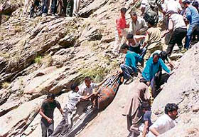 Rescue workers haul the body of a victim up the side of a ravine after a bus plunged into the Chenab in Kishtwar district on Thursday.