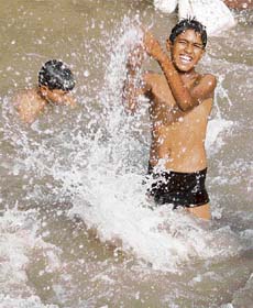 Children playing in a canal to beat heat in Jammu