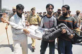 Members of the All-Jammu and Kashmir PHE (ITI) Casual Labour Association carry a casual labourer of PHE, who tried to commit suicide in the Jhelum in Srinagar
