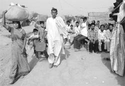 Labourers depart from the Ghaggar riverbed area, near Panchkula, on Friday.