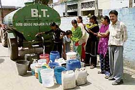 Residents of Abdullahpur colony queue up to collect water from a tanker at Pinjore on Friday.