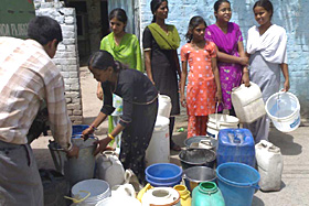 Residents of Abdullahpur colony queue up to collect water from a tanker at Pinjore on Friday.