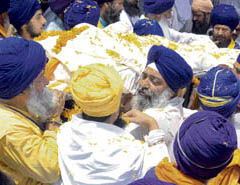 Nihangs carry the body of Baba Santa Singh for cremation in Patiala on Friday.