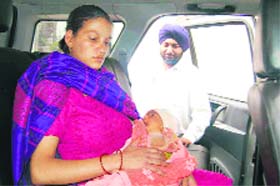 Sarita, the mother, with her baby in Tata Safari at Pinjore while Dr V.P. Singh looks on