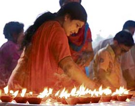 A woman lights lamps in memory of the martyrs of the 1857 War of Independence at a function organised by a social organisation in Karnal on Saturday. 