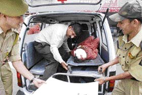 An injured bus passenger is being rushed to a hospital in Jammu