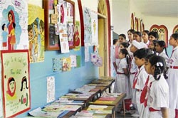 Students of GMT School take a look at the posters and greeting cards during an exhibition organised to mark Mothers Day on the school campus in Ludhiana
