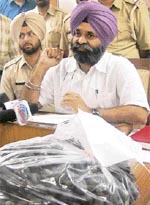 SSP, SAS Nagar, R.S. Khatra shows the seized charas in his office in Mohali 