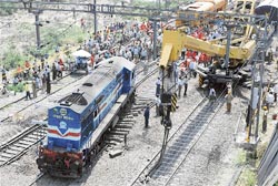 The Railway staff repair the tracks after a train derailed blocking the traffic for several hours at Jalandhar railway station