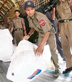 Myanmar military officials unload delivery of blankets and tents from a cargo plane of the Russian emergencies ministry at Yangon on Saturday.