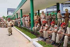 Police personnel gather for an election meeting at Shivalik Public School in Mohali