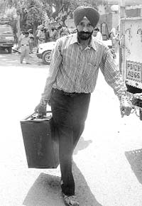 A man collects a ballot box for the panchayat elections in Mohali
