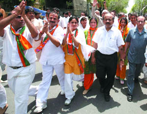 Delhi BJP Pradesh president Harsh Vardhan and Member of Parliament Vijay Kumar Malhotra along with supporters in an election rally at Delhi Cantt in the Capital on Sunday. 