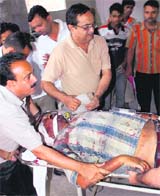 Body of photojournalist Ashok Sodhi is brought to a hospital for postmortem in Jammu on Sunday.
