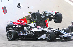 Force India Formula One driver Giancarlo Fisichella of Italy (top) and Williams Formula One driver Kazuki Nakajima of Japan crash after the start of the F1 Grand Prix of Turkey at Istanbul Park on Sunday.