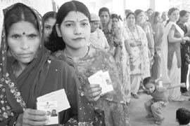 Women queue up to cast their vote during the block samiti and panchayat elections at Balongi village in Kharar