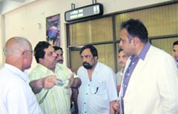 Mediapersons argue with airport station manager S.K. Sharma at the Kangra airport