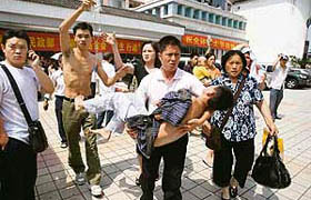 Medical staff and family members evacuate patients from a hospital in Chongqing after an earthquake measuring 7.8 rocked neighbouring Sichuan province.