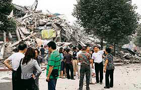 Family members gather at the remains of the collapsed Juyuan middle school where six children died in Dujiangyan, in southwest China Sichuan province.