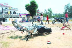 A motorbike lying damaged after a clash between SAD and Congress workers at Dhapai village in Kapurthala.
