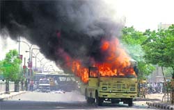 A bus is set on fire after an accident near Ansal Plaza, Ludhiana, on Monday.