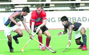Belgiums Charles Vandeweghe (C) battles for the ball against Indias Sarvanjit Singh (L) and Innocent Kullu during their match at the 17th Sultan Azlan Shah Cup in Ipoh, Malaysia on Monday. 