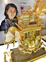 A Japanese woman gazes at an elephant-shaped liqueur tantalus, 66cm tall and weighing 57kg, made by French luxury crystal maker Baccarat, priced at $6,12,000 during the Baccarat's exhibition and sale at Tokyo's Mitsukoshi department store on Tuesday.