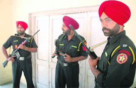 Jawans of the Punjab Police commando force guard ballot boxes at Rink Hall in Patiala on Tuesday.