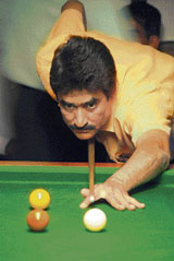A cueist concentrates to pot the ball during the VII Saurabh Khattar Memorial Billiards and Snooker Championship at Chandigarh Club, Sector 1, on Tuesday.