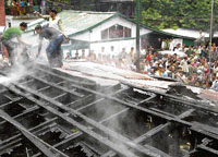 Fire brigade officials and local residents try to control the fire that broke out in Lady Willingdon Hospital, Manali, on Tuesday.