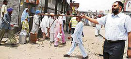 SSP Naunihal Singh disperses BJP agitators at the bus stand in Bathinda on Tuesday.