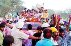 SAD Zila Parishad candidate from Burj Tharor constituency, Gurpreet Singh Maluka, greets his cheering supporters after winning the elections; Akali Dal supporters