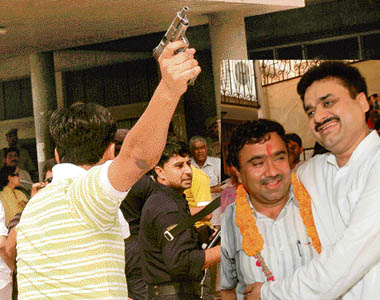 The PSO of Chander Mohan fires into the air at the mini secretariat in Panchkula on Wednesday.