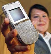 A model presents a mobile phone 'Angel of the Stars', covered with white gold and 1,700 natural diamonds at a price of 1,79,000 euros ($2,76,360) on the first day of the Luxurious Millionaire Fair in Munich on Thursday. The fair, presenting various luxury goods, will last until May 19.