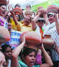 Actvists of the Delhi BJP Mahila Morcha protest against the Delhi government on the issue of water shortage at the Delhi Jal Board office in the Capital on Thursday.