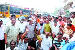 Congress workers block the Jalandhar-Kapurthala road near Basti Bawa Khel in Jalandhar on Thursday.
