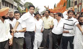 Activists of the Bharatiya Janata Yuva Morcha hold a protest march against galloping prices in Ludhiana on Thursday.