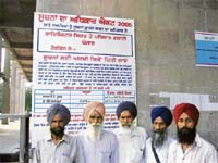 The villagers, who lost eyesight after cataract surgery, at the office of the director, health services, Punjab, in Chandigarh.